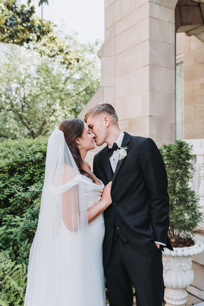 bride pulls groom in for a kiss