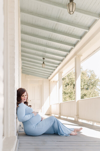 Professional maternity picture of a couple in gorgeous golden light, gazing down at her belly.