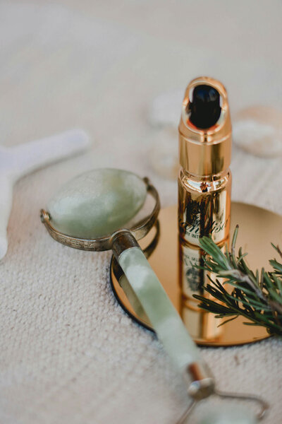 Jade roller for lymphatic drainage during a facial treatment in Monroe, CT.