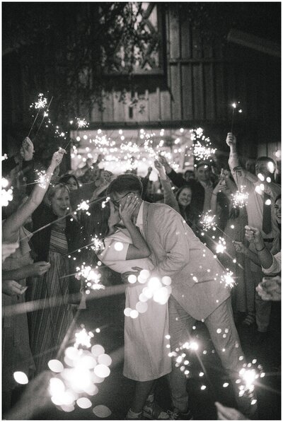 Sacramento Wedding Photographer captures bride and groom dancing along the water after forest wedding