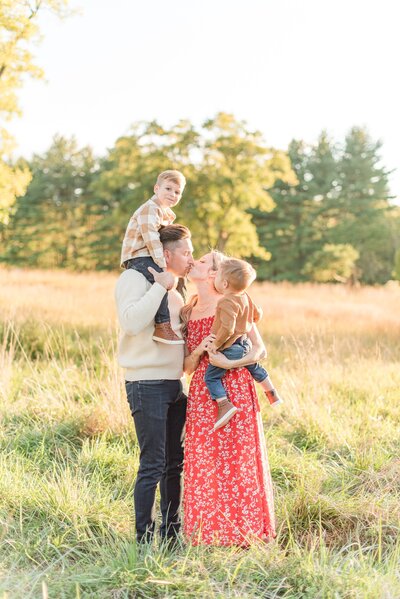family of 4 in a sunny field