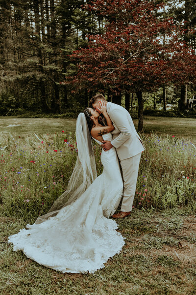 Couple about to kiss in a spot where there are grass with an ocean view