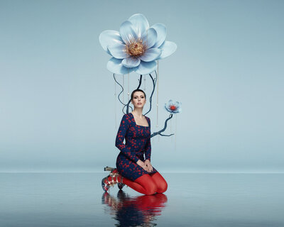 Conceptual portrait of Jasmina Kimova with a surreal flower, representing creative identity and artistic storytelling.
