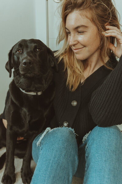 Bare Bones Photo photographer smiling outdoors in Seattle with her dog by her side