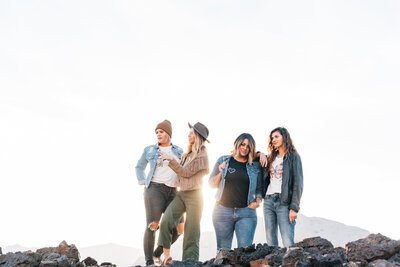 four woman on a mountain top