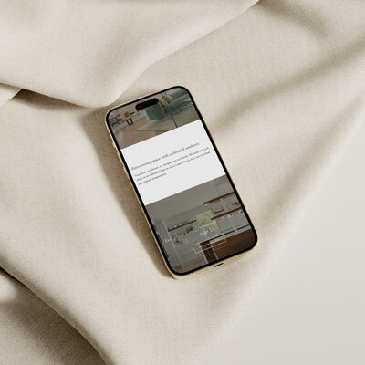 iPhone mockup of Urban Dwellings Interior Design website  with neutral fabric background