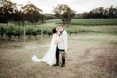 Bride and Bride kissing at Hay Shed Hill