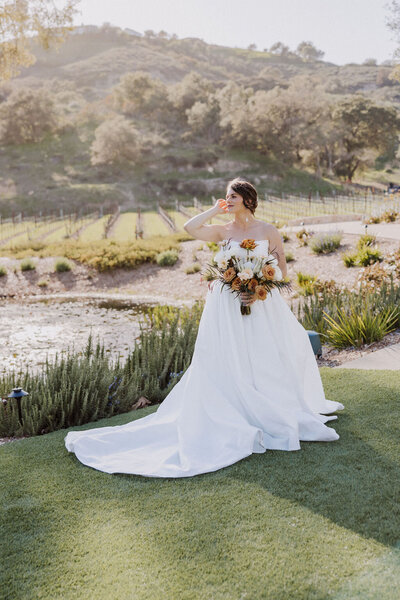 Golden hour bride at Monserate Winery in Temecula, by the lake with the vineyard in background.