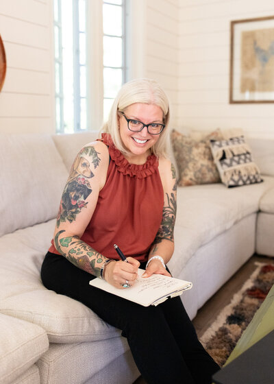 Female sitting on couch in farmhouse-style home during a branding photography session with Portland brand photographer. 