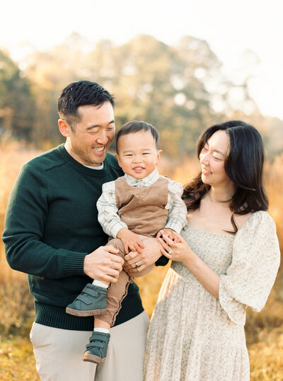 Family smiling during their family portrait session in Wake Forest, NC. Photographed by Raleigh family photographer A.J. Dunlap Photography.