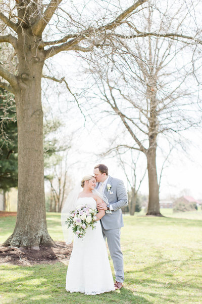 textured wedding bouquet with greens, whites, and purples at oaks lakeside wedding