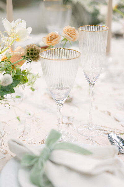 Elegant wedding table setting in Charleston featuring fine glassware, floral arrangements, and soft pastel tones. Capturing luxury wedding details with a timeless, sophisticated touch. Wedding photographer, Charleston, SC.