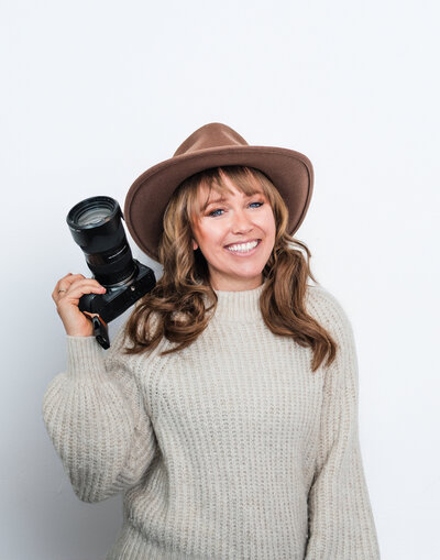 Photographer Lexi Richardson smiles with her camera in Glacier National Park in western Montana.