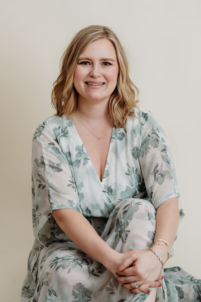 women in blue dress on grey background in photography studio