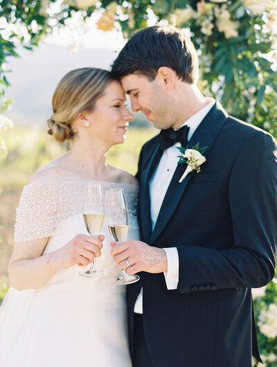 Champagne toasts of newly married couple in napa valley