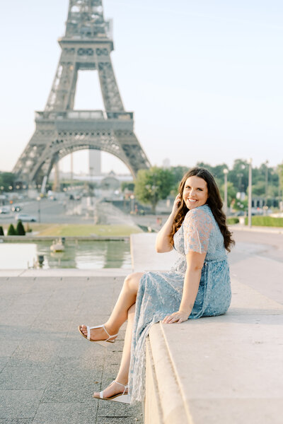 jacksonville florida wedding photographer dana in blue dress sitting on ledge. 