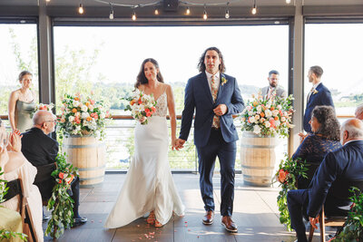 Wedding couple holding hands while walking