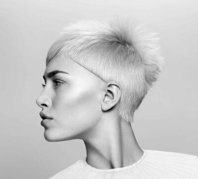 Textured platinum blonde hairstyle emphasising expert styling by blonde specialists in Sydney.