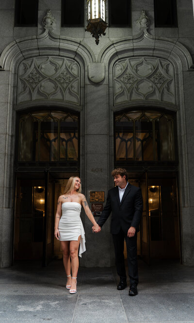 Engagement portraits in front of historic architecture — Des Moines wedding photographers The Proper Collective.