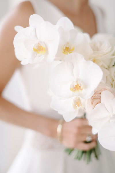 white orchid and pastel roses wedding bouquet