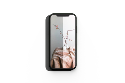mockup of a smartphon showcasing the preset action on a pink linen tablecoth and vas with cherry blossom branches