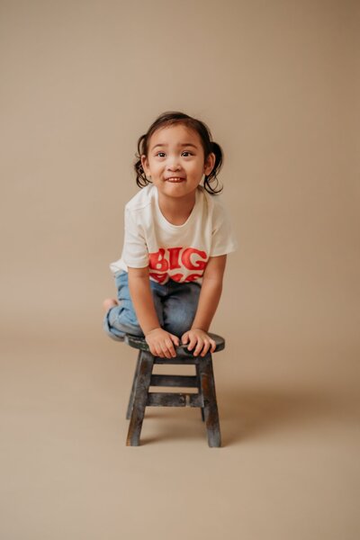 baby crawling and looking above camera for her studio portrait photo session