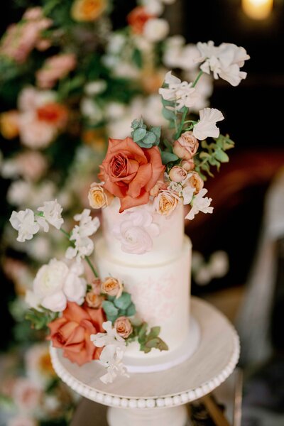 neon sign on pink florals that reads, "the beginning of forever"