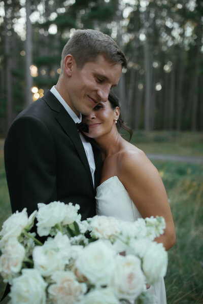 bride and groom dancing close while talking about their wedding day 
