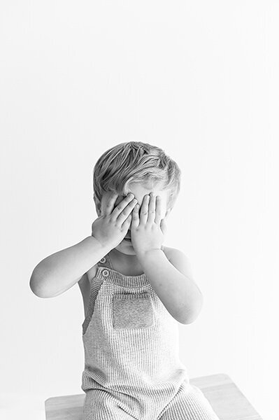 Boy covering his eyes