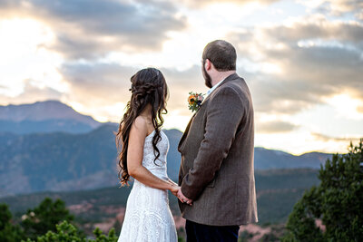 A newly wed couple enjoys a beautiful Colorado sunset as the sun slips behind the mountains