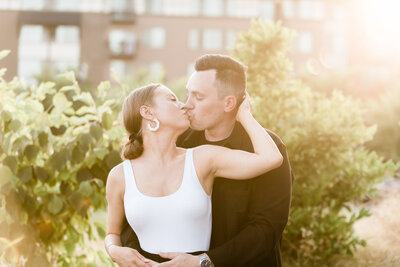 Couple kissing and embracing each other during the sunset. Captured in Bothell by Seattle Engagement Photographer