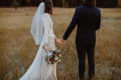 Bride and groom hold hands