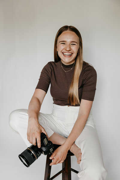 Portrait of Kiana Grant, founder of Kiana Grant Photography, smiling in a natural light setting.