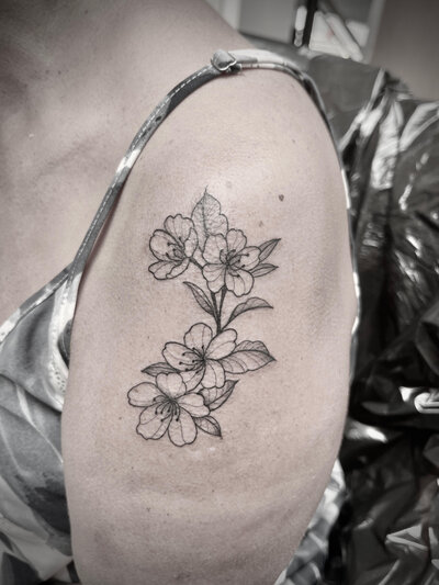 Fine line floral tattoo by Vamp Ink'd