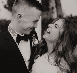 A bride and groom laughing together