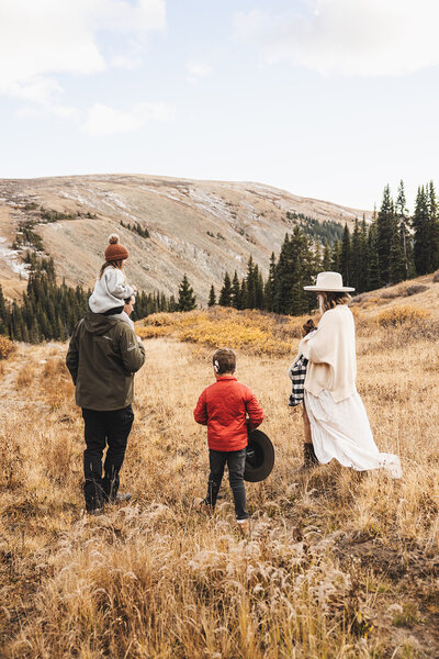 A candid photo of a family of 4 taking professional pictures at Lake Dillon in Breckenridge, Colorado