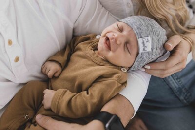 Upstate NY newborn photographer, mom and dad snuggling baby boy