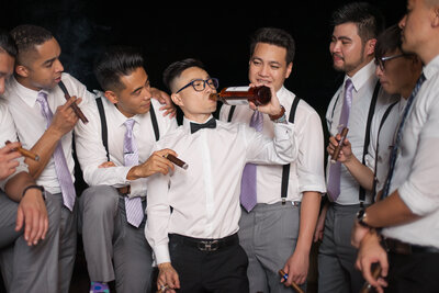 Groom taking a drink with his Groomsmen photographed by Austin TX based Wedding Photographer Lydia Teague