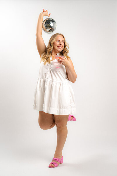 Amy celebrating her business tech support success by holding a disco ball