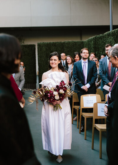 bride walks down the aisle at Los Angeles wedding