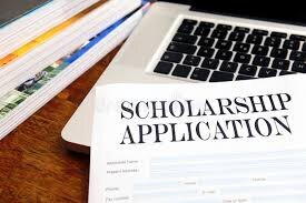 scholarship application resting on laptop