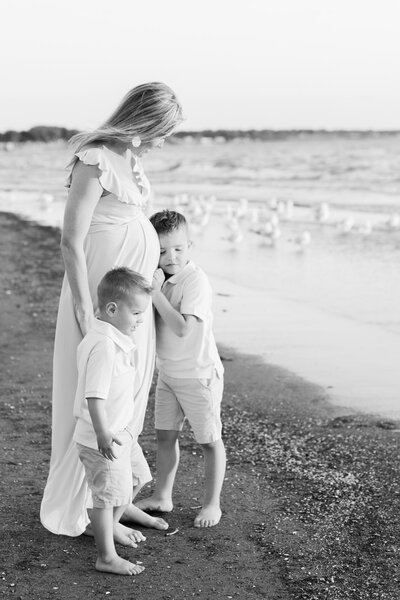 expecting mother at the beach with her children by Florida maternity photographer