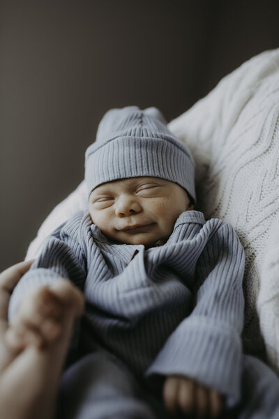 Verona B Photography captures baby details of a newborn – an adorable baby held in his daddy’s arms at an in-home newborn session near Akron, Ohio.