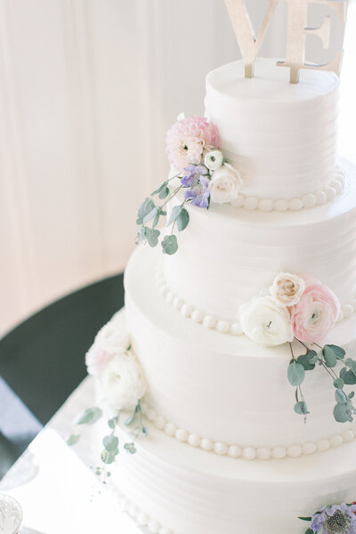 white wedding cake with white and pink flowers