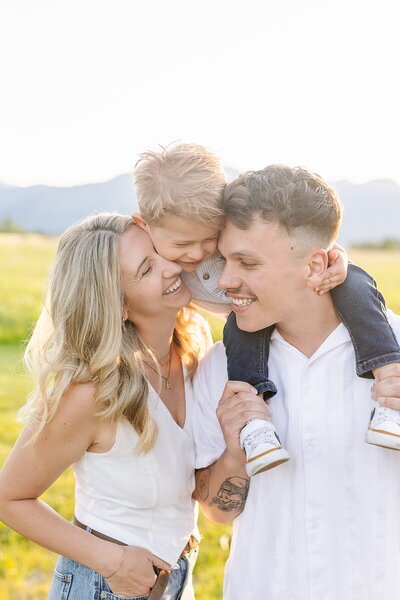 Child kissing mom's baby bump at maternity session at South Lake Park in San Marcos, California.