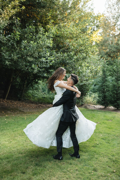 Groom spinning bride in arms captures by Arizona wedding photographer