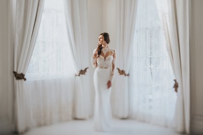 Bride at wedding venues in Lafayette La Standing at window