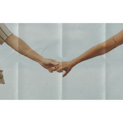 couple holding hands on the beach in delaware