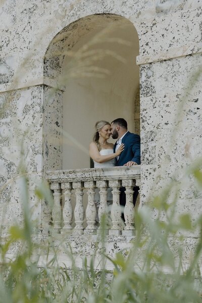 couple embraces during photo session after wedding in south florida