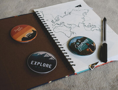 World map in a notebook with buttons sitting on top